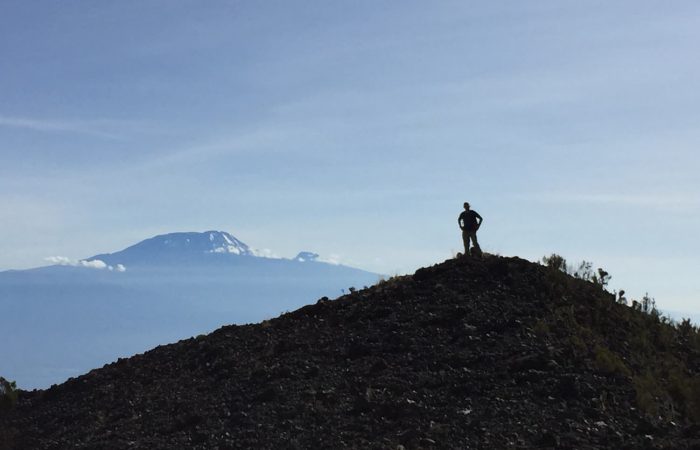 Silhouette of a trekker against mountain views on the Mt. Meru trek
