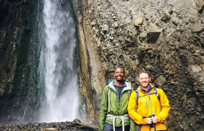 Trekkers in front of the Tululusia Waterfall on the 1-day Mt. Meru trek
