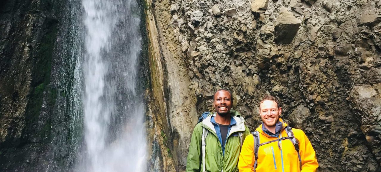 Trekkers in front of the Tululusia Waterfall on the 2-day Mt. Meru trek